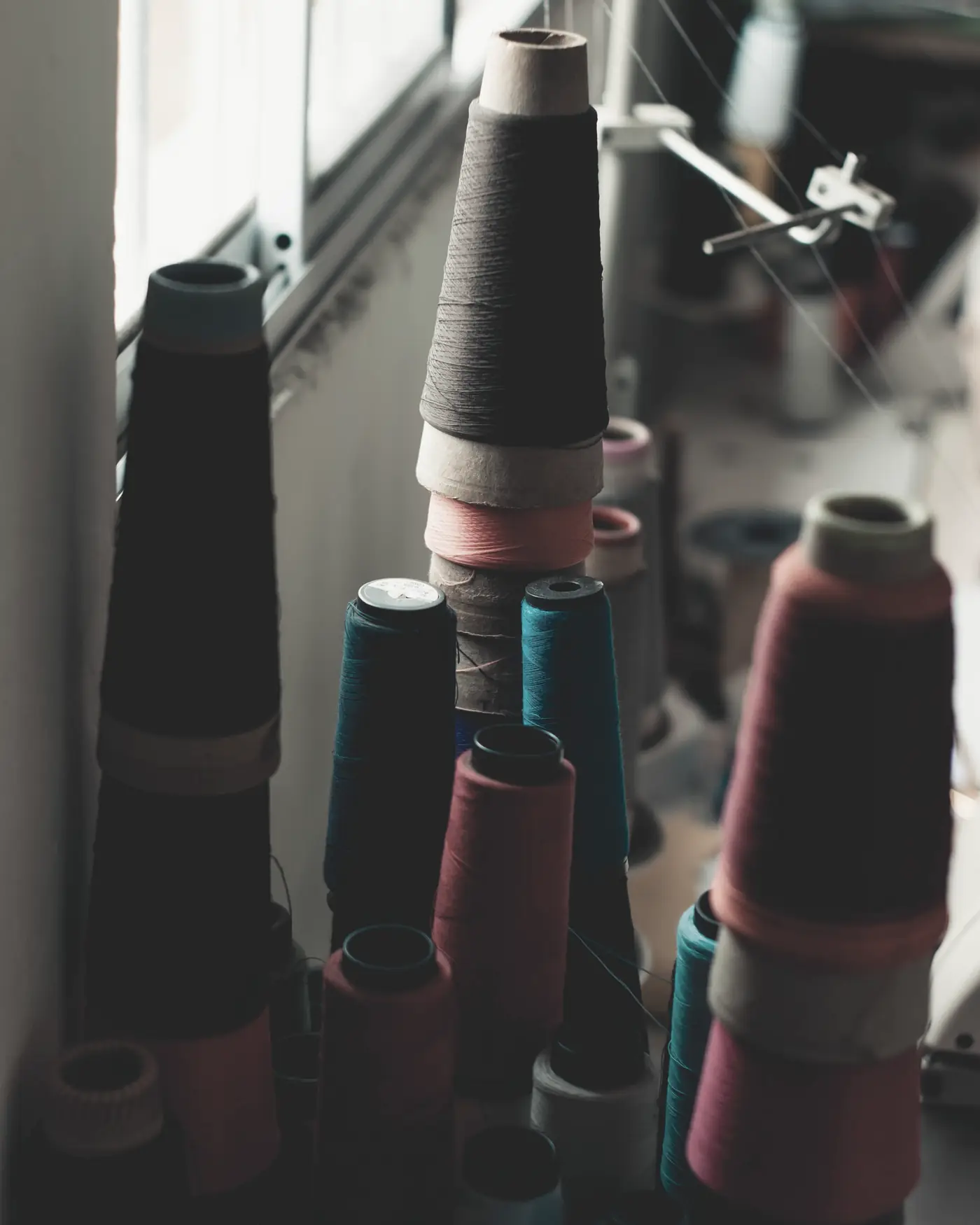 Cones of recycled yarn by a mill window